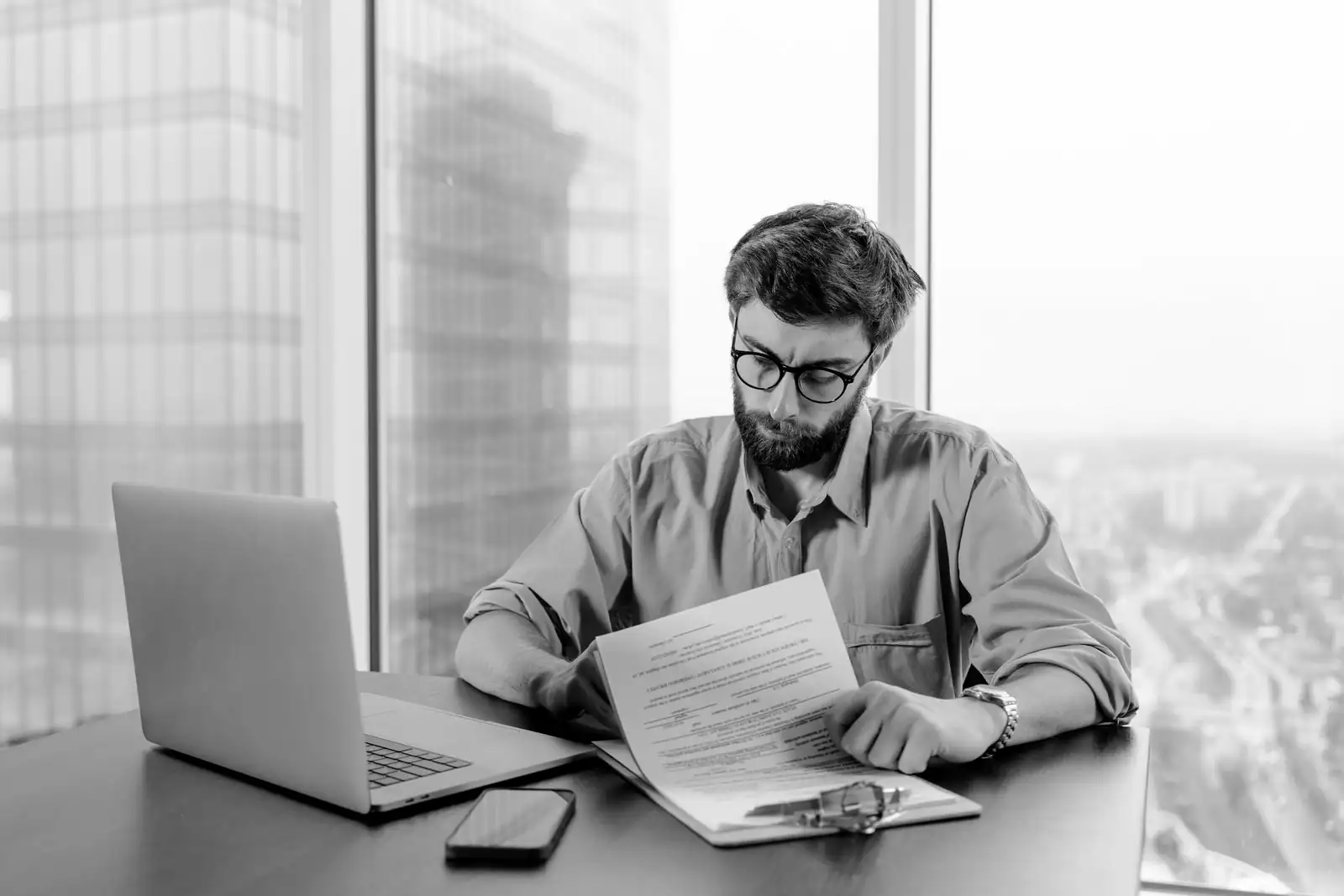 A man reviews a report line by line